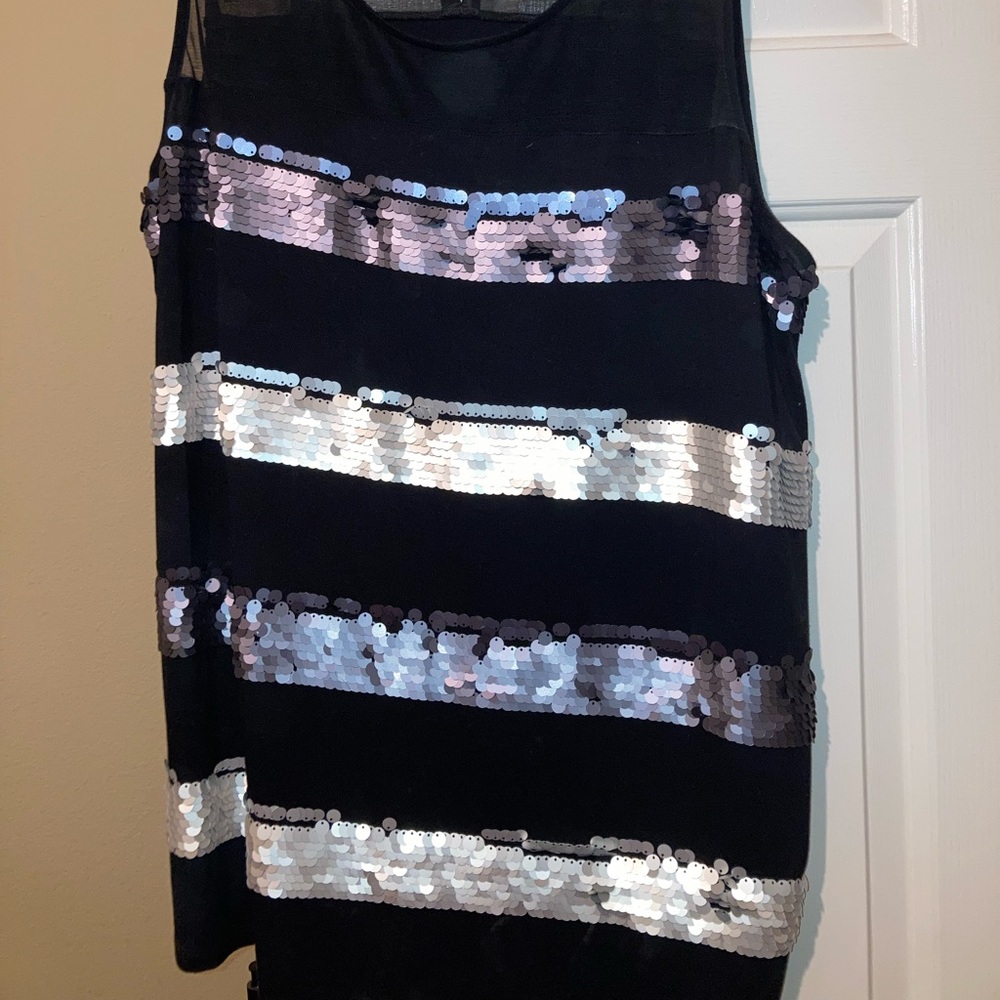 Sparkle this season in a delicate black with silver sequined blouse.